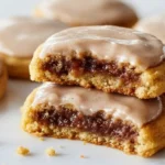 Brown Sugar Pop Tart Cookies with icing, chewy cookie stack on marble, one cookie split to show gooey brown sugar filling, homemade dessert vibe