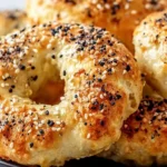 Close up of golden homemade bagels topped with sesame and poppy seeds, showing a fluffy crumb and crisp crust; a bright, healthy breakfast scene featuring Fluffy and Healthy Greek Yogurt Bagels, perfect for easy breakfast and brunch recipes, made with greek yogurt for extra protein, ideal breakfast ideas for quick homemade food.