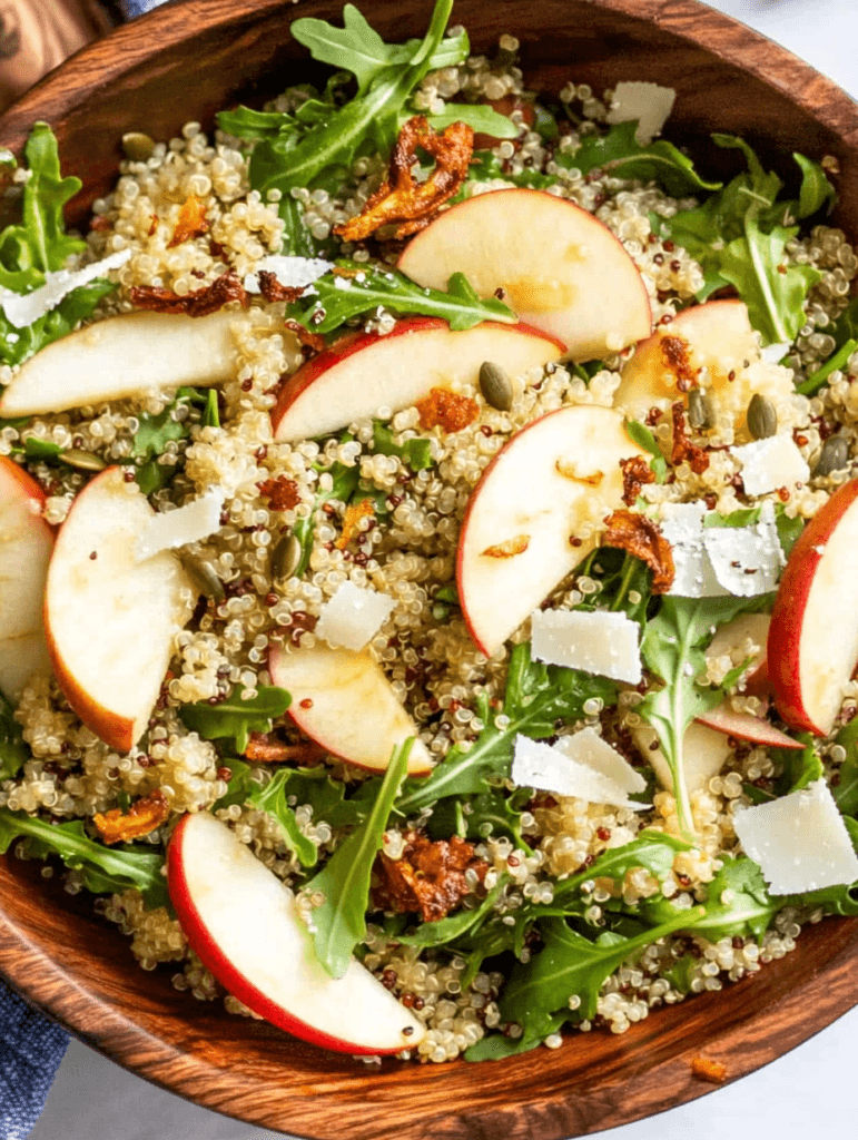 Honey Mustard Quinoa Apple Salad with Crispy Shallots 4 Top-down view of quinoa, greens, and apple slices in a wooden bowl, a true Honey Mustard Quinoa Apple Salad with Crispy Shallots and a tangy honey mustard vinaigrette sheen.