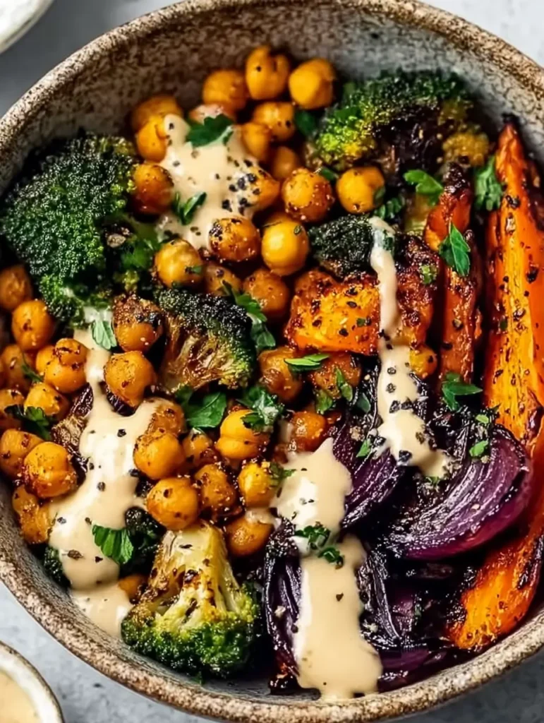 Vegan Roasted Vegetable & Chickpea Bowl with Tahini Sauce 4 A nourishing dinner scene shows a speckled bowl packed with roasted vegetables, roasted veggies chickpeas, and ribbons of tahini dressing, embodying a Vegan Roasted Vegetable and Chickpea Bowl with Tahini Sauce that mirrors roasted veggie tahini bowls and aligns with healthy recipes that celebrate tahini.