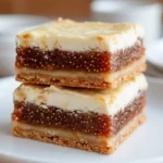 Fig And Cream Cheese Bars stacked on a white plate, buttery shortbread crust, jammy fig filling, creamy cheesecake style topping, easy dessert idea