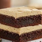 Close-up of two fudgy coffee brownies stacked, topped with creamy mocha frosting, dessert bar photo for Frosted Coffee Brownies Recipe.