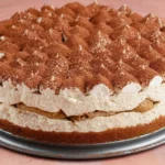 Vegan Tiramisu Cheesecake with espresso soaked layers, creamy plant based filling, and cocoa dusting on a springform base