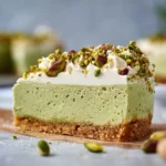Delicious homemade pistachio cheesecake topped with crushed pistachios.