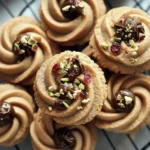 Batch of melt-in-your-mouth coffee butter cookies on a festive plate