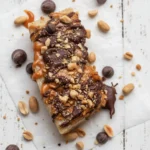 Frozen Banana Snickers dessert with chocolate and nuts on a plate