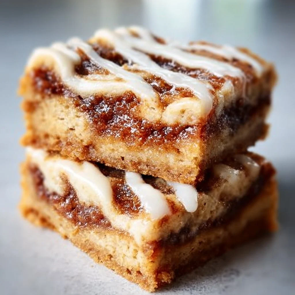 Delicious cinnamon roll bliss bars topped with icing and swirls of cinnamon