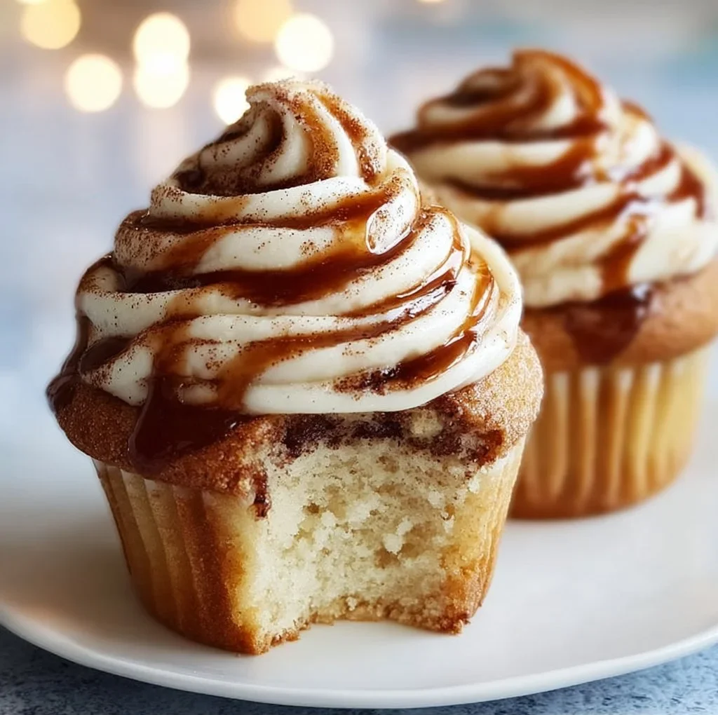 Delicious cinnamon roll cupcakes topped with cream cheese frosting.