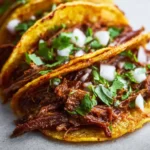 Delicious slow cooker birria tacos served with garnish